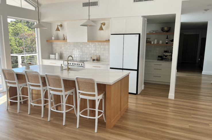 Newly installed and cleaned hybrid flooring kitchen area.